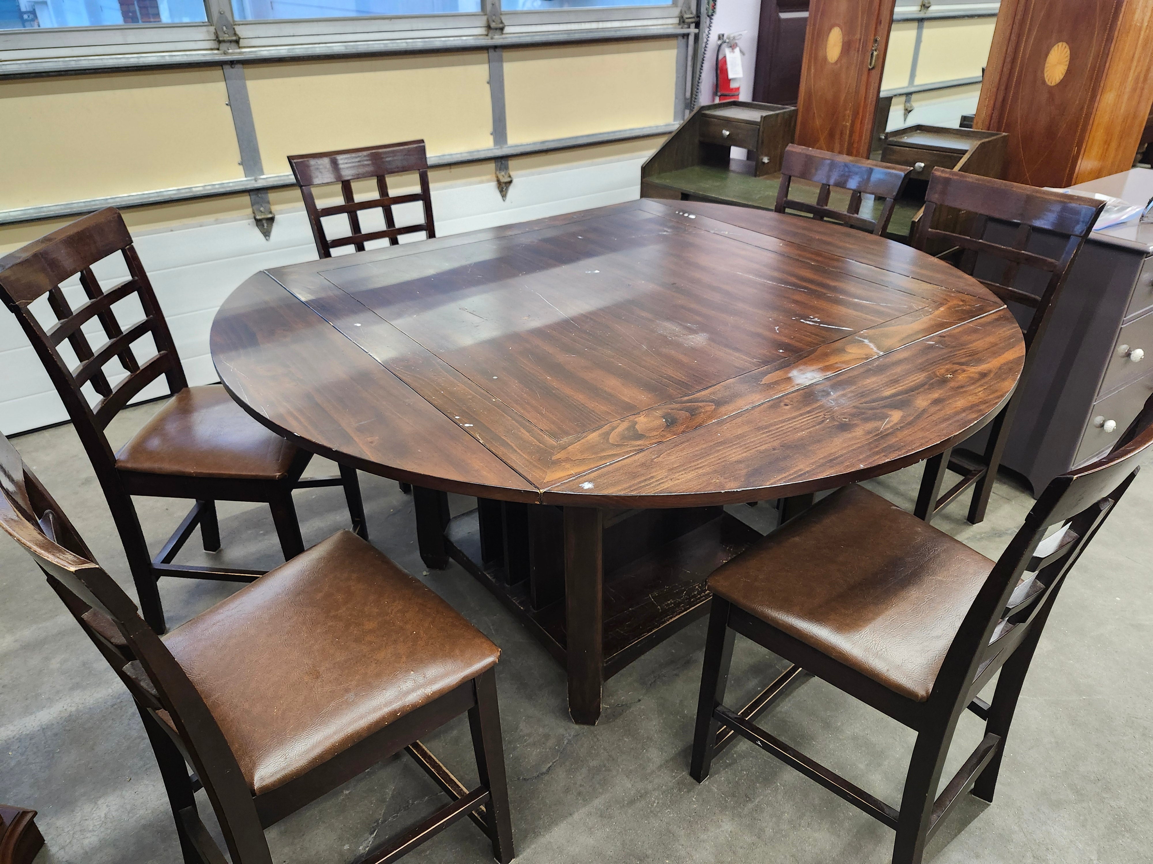 Dining set with 4 drop sides on each corner & 6 chairs with storage underneath table